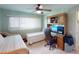 Bedroom with twin beds, desk and ceiling fan at 3448 Nighthawk Ct, Punta Gorda, FL 33950