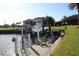 Private boat dock with lift and seating area, perfect for enjoying waterfront living at 3448 Nighthawk Ct, Punta Gorda, FL 33950