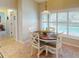 Bright breakfast nook with wooden table and white chairs near kitchen at 3448 Nighthawk Ct, Punta Gorda, FL 33950