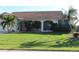 Single story home with terracotta roof and lush landscaping at 3448 Nighthawk Ct, Punta Gorda, FL 33950