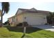 View of the side of a Florida house with a two-car garage at 3448 Nighthawk Ct, Punta Gorda, FL 33950
