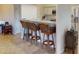 Kitchen boasts a breakfast bar with wicker stools and granite countertops at 3448 Nighthawk Ct, Punta Gorda, FL 33950