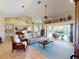 Spacious living room with vaulted ceilings, light tile floors, and access to pool area at 3448 Nighthawk Ct, Punta Gorda, FL 33950
