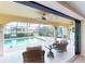 Relaxing screened-in pool and patio with wicker furniture and canal views at 3448 Nighthawk Ct, Punta Gorda, FL 33950
