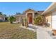 Tan house with red door and landscaped yard at 4061 Atwater Dr, North Port, FL 34286