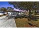 Single-story home with a two-car garage and mature landscaping at dusk at 7146 Sablon Rd, North Port, FL 34291