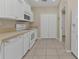 White kitchen with breakfast bar and view of dining area at 7146 Sablon Rd, North Port, FL 34291