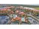Aerial view of community with pools, tennis courts, and waterfront property at 99 Vivante Blvd # 312, Punta Gorda, FL 33950