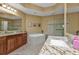 Elegant bathroom with a large soaking tub and granite countertops at 99 Vivante Blvd # 312, Punta Gorda, FL 33950