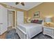 Guest bedroom with white bed frame and wood floors at 99 Vivante Blvd # 312, Punta Gorda, FL 33950
