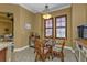 Bright breakfast nook with glass table and wicker chairs at 99 Vivante Blvd # 312, Punta Gorda, FL 33950