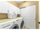 Laundry room with washer, dryer and storage cabinets at 99 Vivante Blvd # 312, Punta Gorda, FL 33950