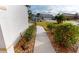 Sidewalk with landscaping leading to the house entrance at 10301 Shadow Run Ct, Punta Gorda, FL 33955