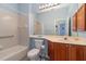 Clean bathroom with a single vanity and tub shower combo at 10494 Princess Ct, Punta Gorda, FL 33955