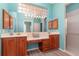 Double vanity bathroom with a large mirror and a walk-in shower at 10494 Princess Ct, Punta Gorda, FL 33955