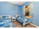 Bright bedroom with twin beds, window, and light blue walls at 10494 Princess Ct, Punta Gorda, FL 33955