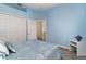 Guest bedroom with a double door closet and light blue walls at 10494 Princess Ct, Punta Gorda, FL 33955