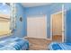 Bedroom with twin beds, large closet, and access to a hallway at 10494 Princess Ct, Punta Gorda, FL 33955