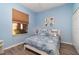 Cozy bedroom with light blue walls and nautical decor at 10494 Princess Ct, Punta Gorda, FL 33955