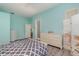 Bedroom with light-colored walls, wood flooring, and a dresser at 10494 Princess Ct, Punta Gorda, FL 33955