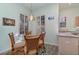 Cozy breakfast nook with a round glass table and wicker chairs at 10494 Princess Ct, Punta Gorda, FL 33955