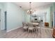 Dining area with light walls, chandelier and large mirror at 10494 Princess Ct, Punta Gorda, FL 33955