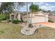 House exterior with a curved walkway and palm trees at 10494 Princess Ct, Punta Gorda, FL 33955