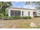 House exterior showcasing a screened patio and manicured lawn at 10494 Princess Ct, Punta Gorda, FL 33955