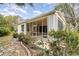 House exterior with screened patio and lush landscaping at 10494 Princess Ct, Punta Gorda, FL 33955