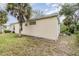 Tan house exterior with palm trees and landscaping at 10494 Princess Ct, Punta Gorda, FL 33955