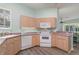 Modern kitchen featuring light wood cabinets, pink countertops, and stainless steel appliances at 10494 Princess Ct, Punta Gorda, FL 33955