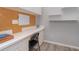 Home office with white cabinets, corkboard, and floating shelves at 10494 Princess Ct, Punta Gorda, FL 33955
