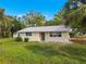 Single-story house with light-yellow siding and a gray roof at 1414 Lemon St, Punta Gorda, FL 33950