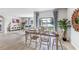 Charming dining area with wooden table and chairs, adjacent to the living room at 1428 Powell Valley Dr, Port Charlotte, FL 33953