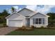 Attractive single-story home with gray siding, white garage door, and landscaping at 1428 Powell Valley Dr, Port Charlotte, FL 33953