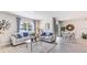 Bright living room features a comfortable sofa, coffee table and dining area at 1428 Powell Valley Dr, Port Charlotte, FL 33953