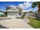 Single-story house featuring a two-car garage and well-maintained lawn at 1600 Redwing Ct, Punta Gorda, FL 33950