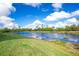 Scenic view of a tranquil pond with lush green grass and clear blue skies at 175 Kings Hwy # 924, Punta Gorda, FL 33983