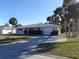 Ranch style home with a carport and mature landscaping at 1785 Elinor Pl, Englewood, FL 34223