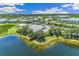 Aerial view of community with clubhouse, pool, tennis courts, and lake at 2051 Royal Tern Cir, Punta Gorda, FL 33983