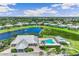 Community pool and clubhouse with surrounding landscape at 2051 Royal Tern Cir, Punta Gorda, FL 33983