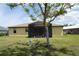 View of the backyard of the house with a screened porch, attached to the house, with potted plants inside the screen at 25115 Esmeralda Ct, Punta Gorda, FL 33955