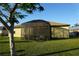Enclosed patio and backyard with lush lawn at 25115 Esmeralda Ct, Punta Gorda, FL 33955