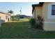 Spacious backyard with grassy area and partial view of neighboring house at 25115 Esmeralda Ct, Punta Gorda, FL 33955