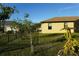 The spacious backyard features a well-maintained lawn, complemented by green plants around the fence line at 25115 Esmeralda Ct, Punta Gorda, FL 33955