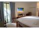 Bedroom with king-size bed and access to patio at 25115 Esmeralda Ct, Punta Gorda, FL 33955