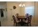 Formal dining room featuring a round wooden table and chandelier at 25115 Esmeralda Ct, Punta Gorda, FL 33955