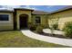 The front of the house with a walkway and small garden at 25115 Esmeralda Ct, Punta Gorda, FL 33955