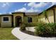 The front of the house with a walkway and small garden at 25115 Esmeralda Ct, Punta Gorda, FL 33955