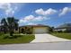 Charming one-story home with yellow siding, a two-car garage, and a well-manicured front lawn at 25115 Esmeralda Ct, Punta Gorda, FL 33955